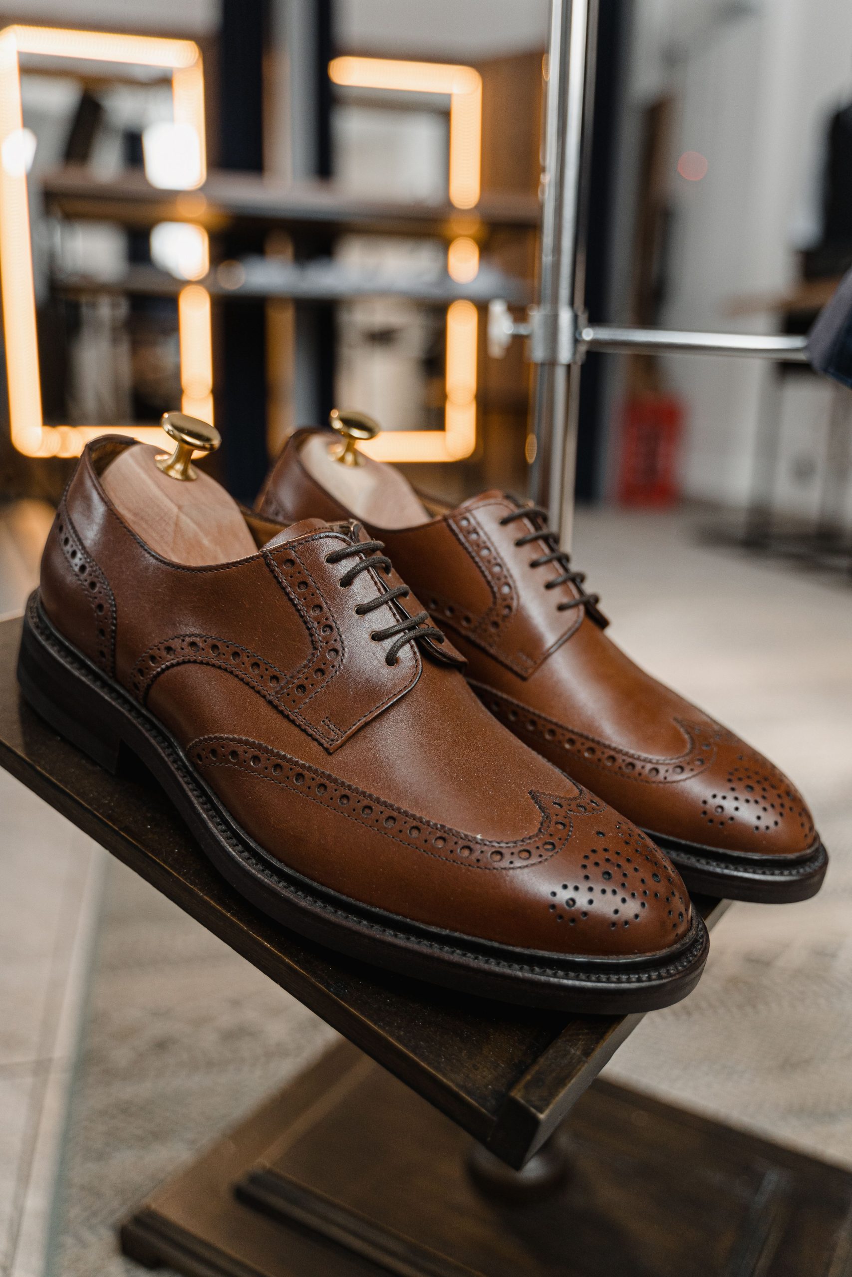Brown leather brogue derbies with shoe trees, examined part by part